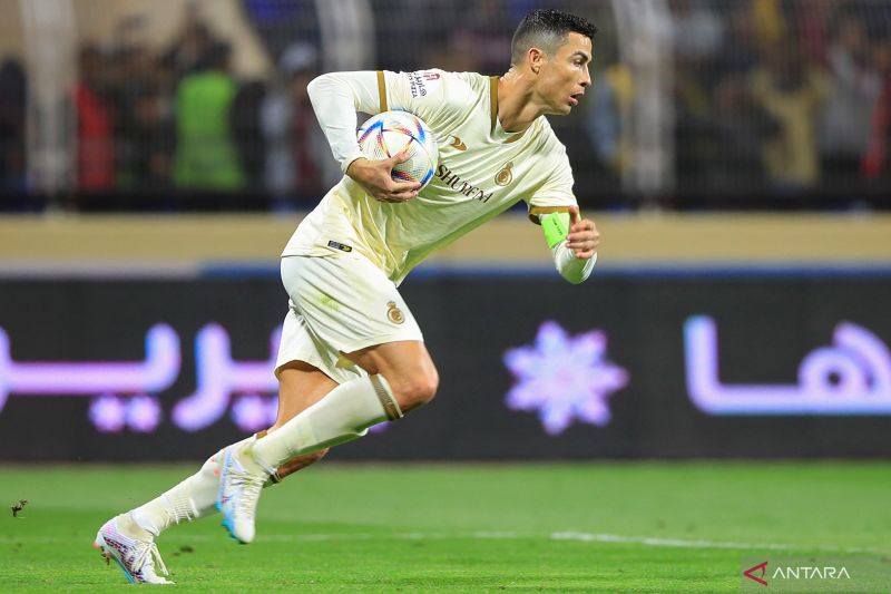 Penyerang Al Nassr Cristiano Ronaldo berlari sambil membawa bola setelah mencetak gol melalui penalti pada pertandingan Liga Arab Saudi melawan Al Fateh, yang dimainkan di Stadion Pangeran Abdullah bin Jalawi, Al Hasa, Jumat (3/2/2023)